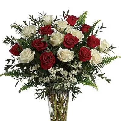 Red and white roses in a clear glass vase