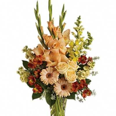 Peach and cream mixed bouquet in a clear glass vase