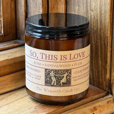 Amber candle jar with black lid and labeled scent name