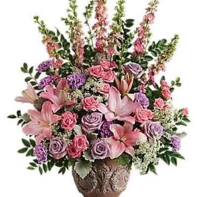 Tall pink and lavender floral arrangement in an ornate brown vase