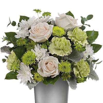 Bouquet of pale roses, white daisies, and green carnations in a glass vase