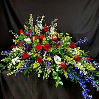 Large spray of red, white, blue, and yellow flowers on a dark background