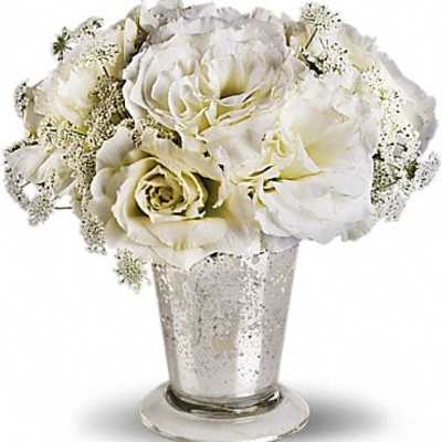White roses arranged in a silver vase