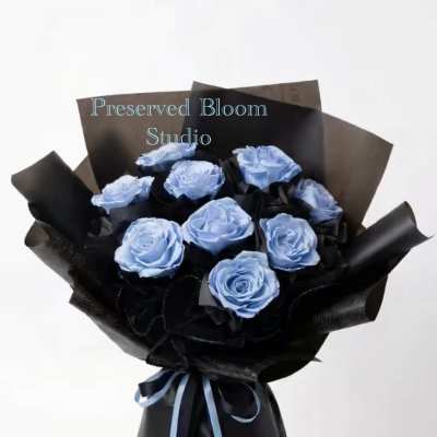 Bouquet of light blue roses wrapped in black paper with a blue ribbon
