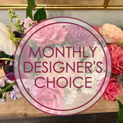 Mixed bouquet of pink, white, and purple flowers with a designer's choice label