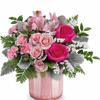 Pink roses and alstroemeria in a pink glass vase