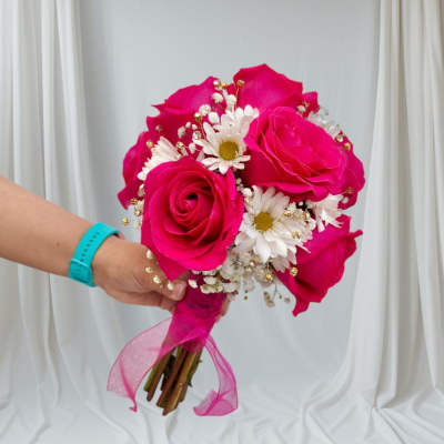 Handheld bouquet of hot pink roses and white daisies with a pink ribbon