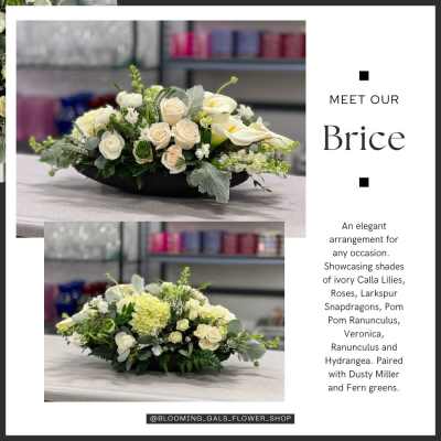 Low ivory floral arrangement in a black container with roses and calla lilies