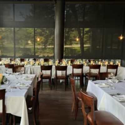 Wedding reception tables with white linens and small floral centerpieces