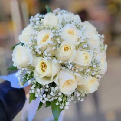 White rose bridal bouquet with baby's breath and ribbon
