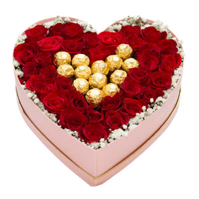 Heart-shaped pink box filled with red roses and gold-wrapped chocolates in the center.
