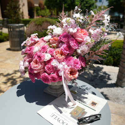 Pink and white rose bouquet in a pedestal vase