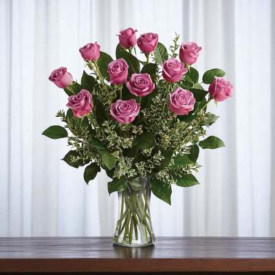 Pink roses arranged in a clear glass vase