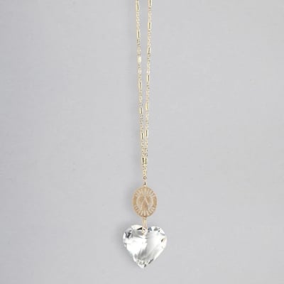 Gold chain necklace with engraved disc and clear heart-shaped crystal pendant