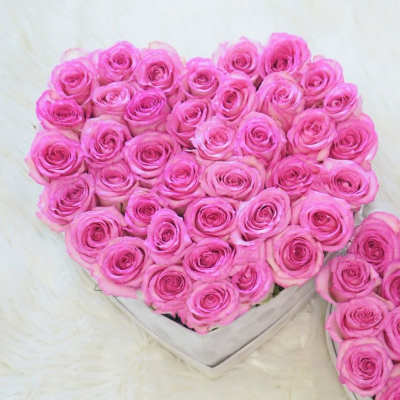 Heart-shaped bouquet of pink roses in a white box