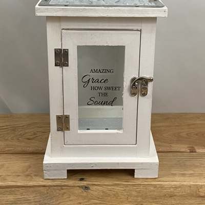 White decorative lantern with a metal handle and glass door