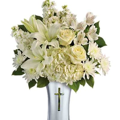 White floral arrangement in a silver vase with a cross cutout