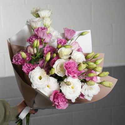 Bouquet of pink and white lisianthus wrapped in paper