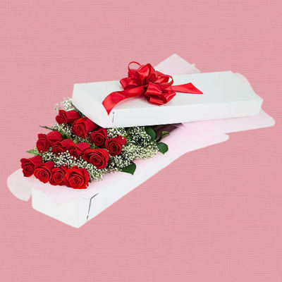 Red roses in a white gift box with a red ribbon