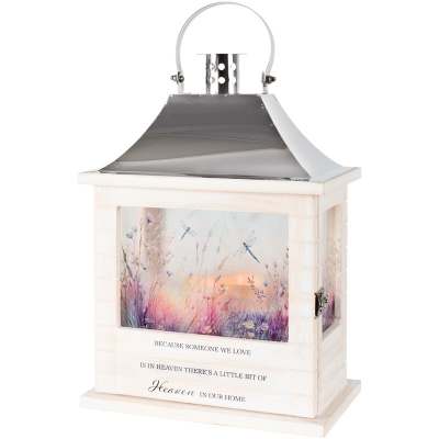 White memorial lantern with metal roof and painted meadow scene with dragonflies.