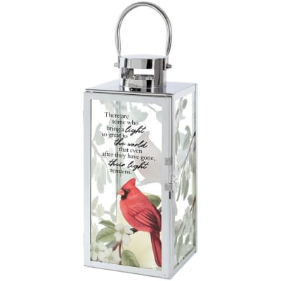Tall white metal lantern with a red cardinal, white blossoms, and an inspirational quote on the glass.