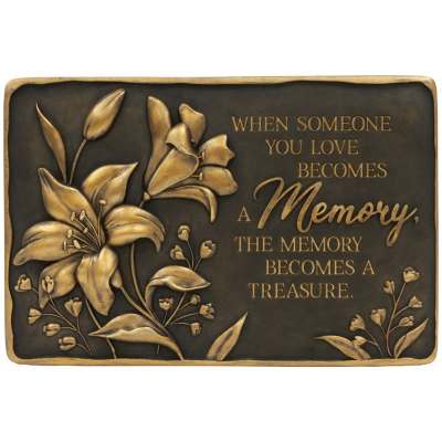 Bronze-tone memorial plaque with raised lilies and sympathy verse.