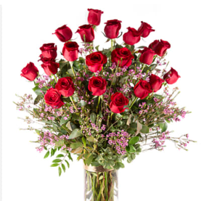 Tall bouquet of red roses in a clear glass vase