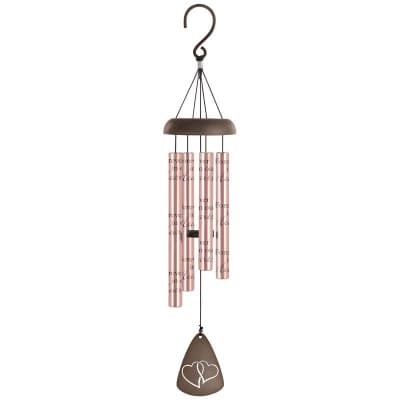 Metal wind chime with pink tubes, scripted text, and a heart motif on the hanging sail