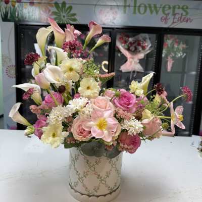 Pink and white mixed bouquet in a floral-patterned vase
