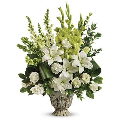 Tall white lily and rose arrangement in an ornate ivory urn vase
