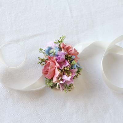 Small pastel floral wrist corsage with ribbon ties