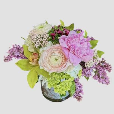 Pastel floral arrangement in a vase with pink and lavender blooms