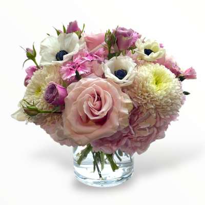 Pink and white bouquet in a clear glass vase