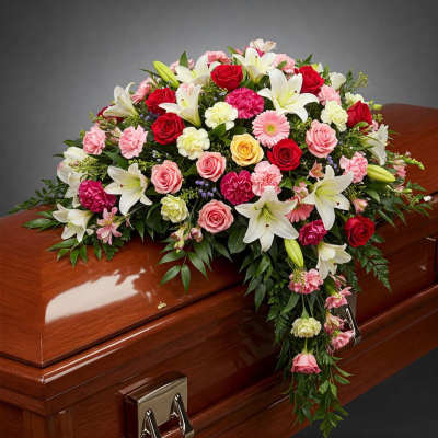 Casket spray with red, pink, and white flowers