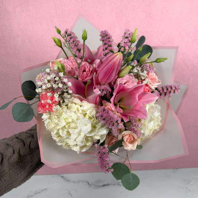 Pink and white bouquet with lilies, hydrangeas, and roses