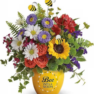 Mixed bouquet in a yellow vase with bee decorations