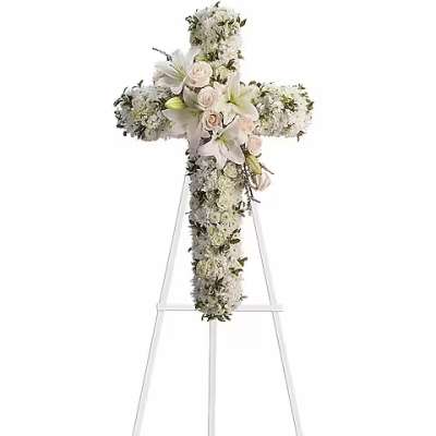 White floral cross on a clear stand
