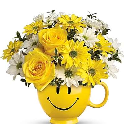 Yellow roses and white daisies in a smiley-face mug