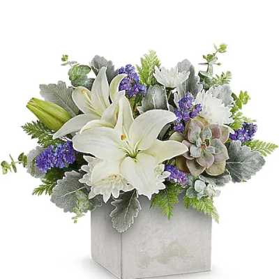 White lilies and purple flowers arranged in a square gray vase