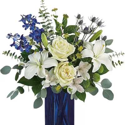 White lilies and roses in a blue glass vase