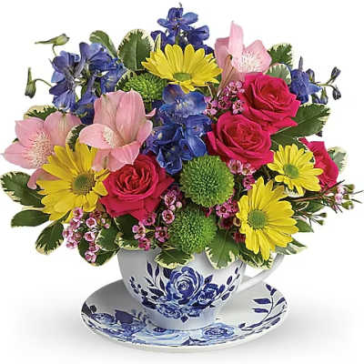 Colorful mixed bouquet in a blue-and-white teacup and saucer