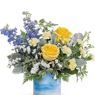 Yellow roses and blue flowers arranged in a blue glass vase