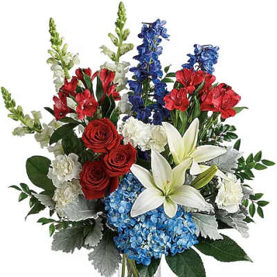 Bouquet of red roses, white lilies, blue hydrangeas, and mixed blooms in a glass vase