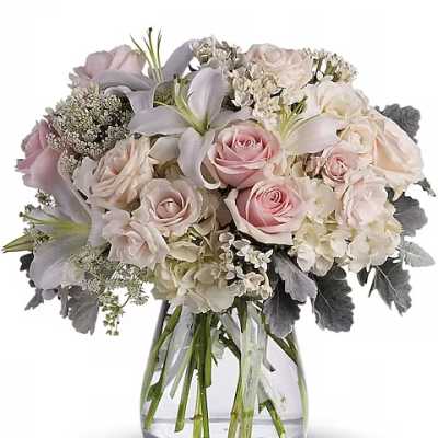 Pink and white rose bouquet in a clear glass vase