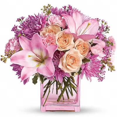 Pink lilies and peach roses in a pink glass vase