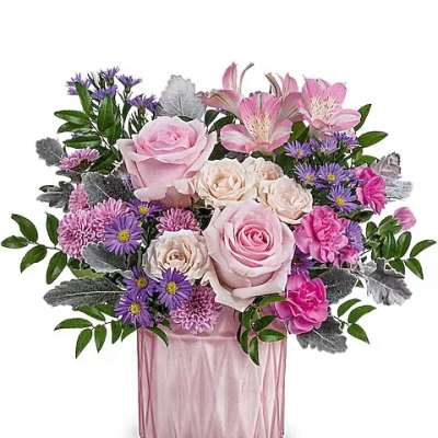 Pink and purple mixed bouquet in a pink glass vase