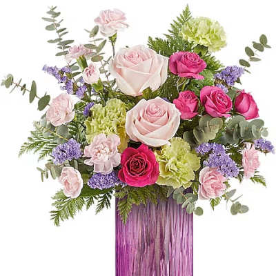 Pink and white rose bouquet in a purple glass vase