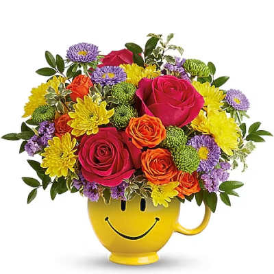 Colorful bouquet in a yellow smiley-face mug