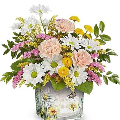 Mixed bouquet of daisies, carnations, and yellow filler flowers in a decorative vase