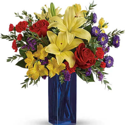 Bouquet of yellow lilies, red roses, and purple flowers in a blue vase